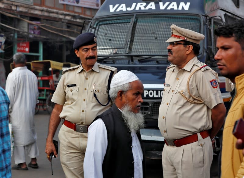 Police officers stand guard in a street outside Jama Masjid, before Supreme Court's verdict on a disputed religious site claimed by both majority Hindus and Muslim in Ayodhya, in Delhi