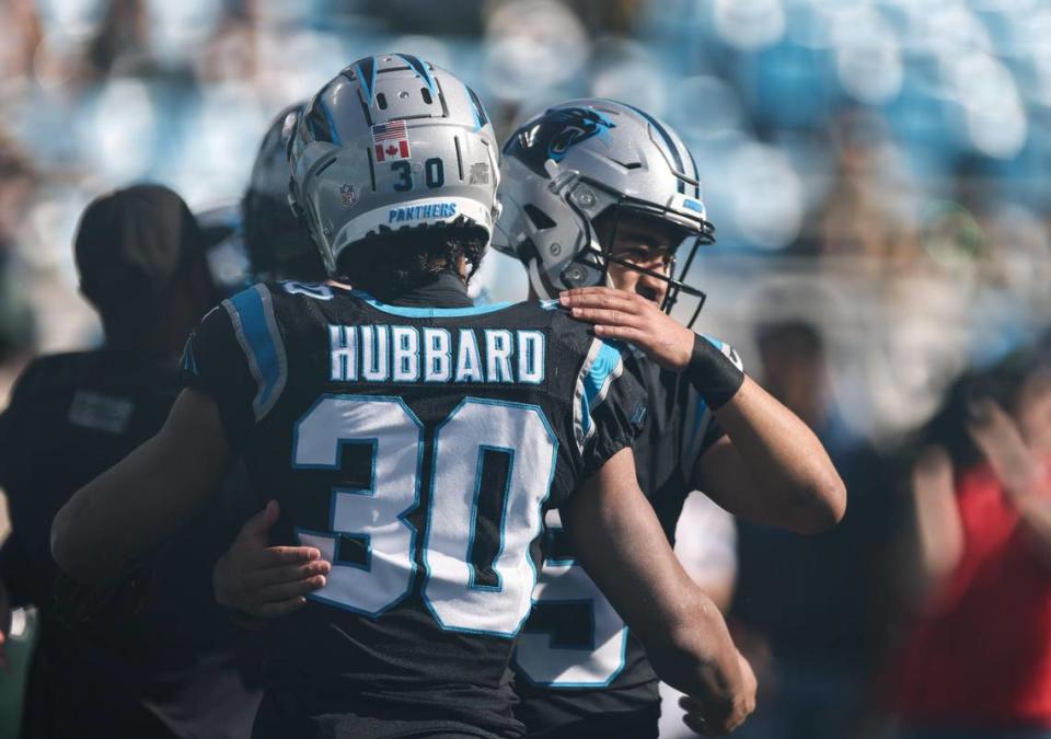 Carolina Panthers quarterback Bryce Young (9), right, greets Carolina Panthers running back Chuba Hubbard (30)at the Bank of America Stadium before the game against the Green Bay Packers in Charlotte, N.C., on Sunday, December 24, 2023.