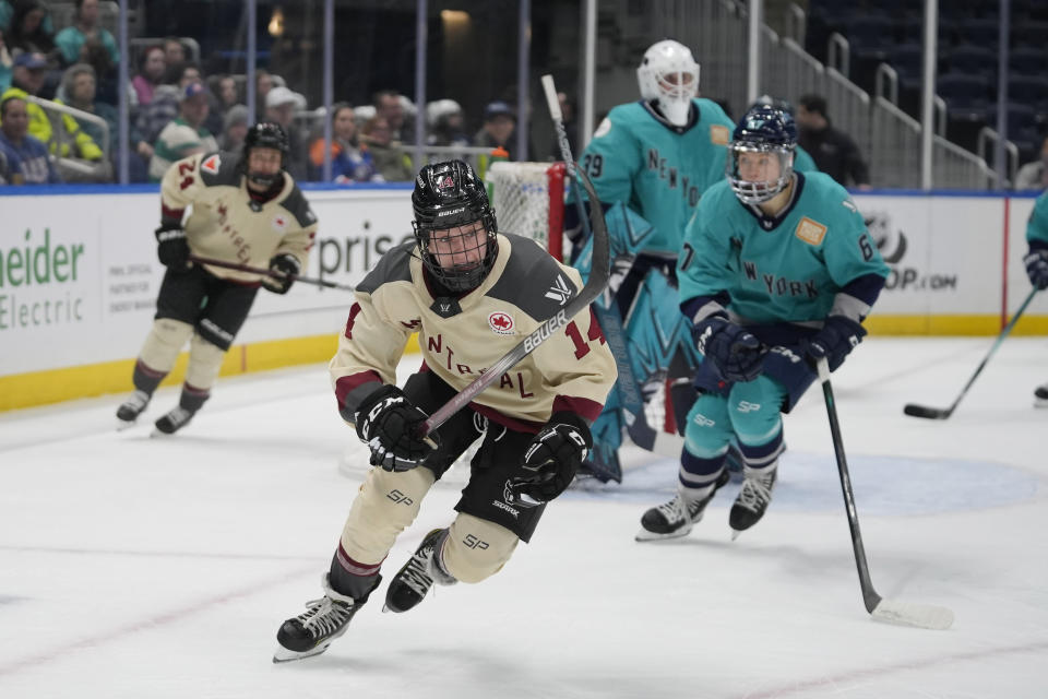 Montreal orward Jillian Dempsey (14) chases the puck during the first period of the team's PWHL hockey game against New York on Wednesday, Feb. 21, 2024, in Elmont, N.Y. (AP Photo/Peter K. Afriyie)