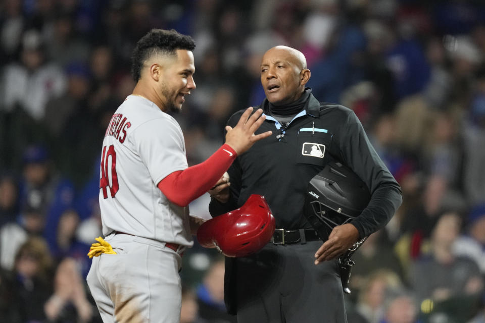 St. Louis Cardinals' Willson Contreras with home plate umpire CB Bucknor, after Bucknor earlier gave Contreras a strike on a pitch clock violation during the sixth inning of a baseball game on Monday, May 8, 2023, in Chicago. (AP Photo/Charles Rex Arbogast)