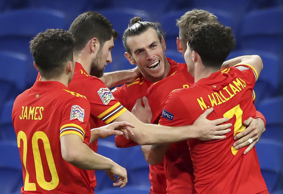 Wales' Gareth Bale, center, and teammates celebrate their first goal scored by David Brooks, 2nd right, during the UEFA Nations League soccer match at Cardiff City Stadium, Cardiff, Wales, Sunday Nov. 15, 2020. (Nick Potts/PA via AP)