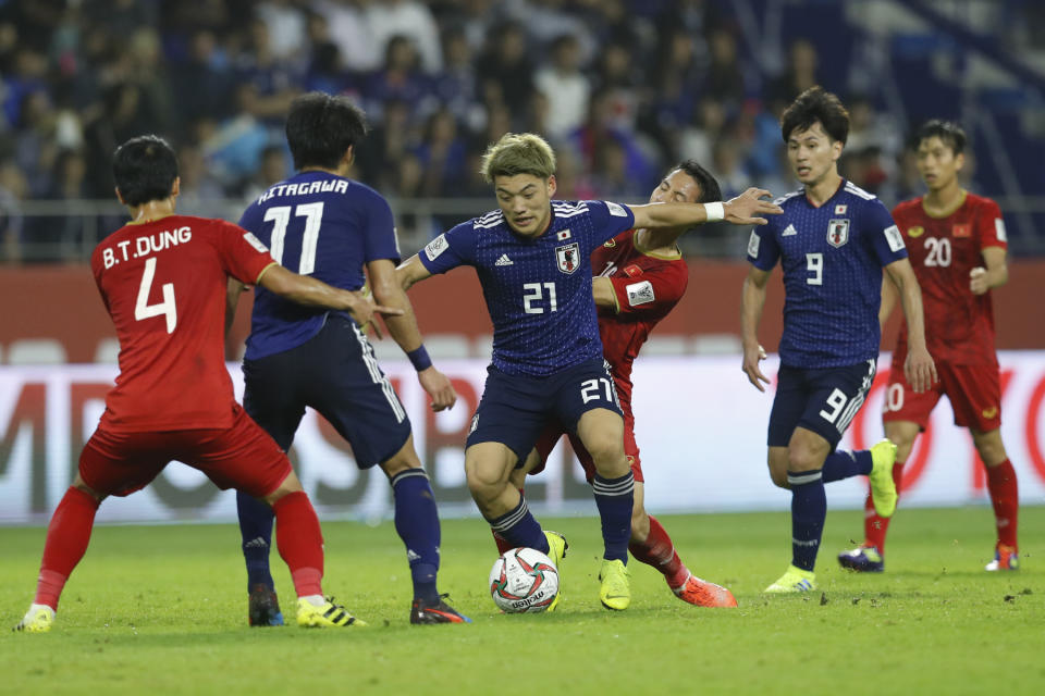 Japan's midfielder Ritsu Doan controls the ball past Vietnam's midfielder Do Hung Dung during the AFC Asian Cup quarterfinal soccer match between Japan and Vietnam at Al Maktoum Stadium in Dubai, United Arab Emirates, Thursday, Jan. 24, 2019. (AP Photo/Hassan Ammar)