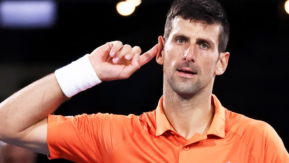 Novak Djokovic points to his ear after winning a point at the Adelaide International.