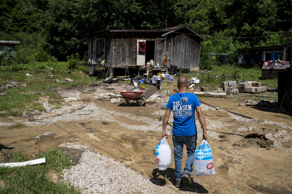 Image: James Henry White carries ice to his father in Caney, Ky. on Aug. 3, 2022. (Michael Swensen for NBC News)
