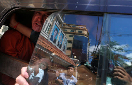 Australian filmmaker James Ricketson shouts inside a prison truck as he leaves the Municipal Court of Phnom Penh, Cambodia, August 31, 2018. REUTERS/Samrang Pring