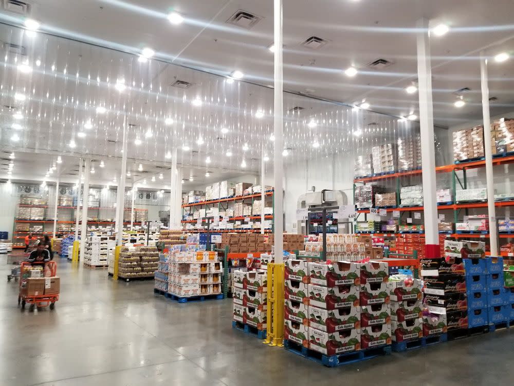 One lone shopper is shown amidst a brightly lit section of a Costco Business Center.