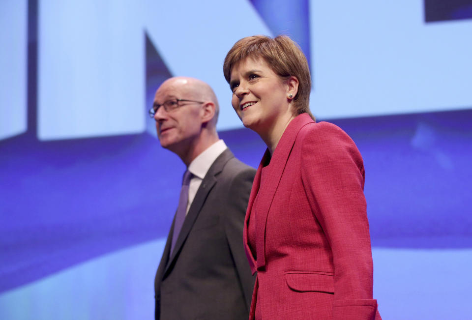 Scotland's First Minister, Nicola Sturgeon, and Deputy First Minister, John Swinney arrive for the opening address to delegates at the Scottish National Party conference at the SEC Centre in Glasgow, Scotland, Sunday Oct. 8, 2017. ( Jane Barlow/PA via AP)