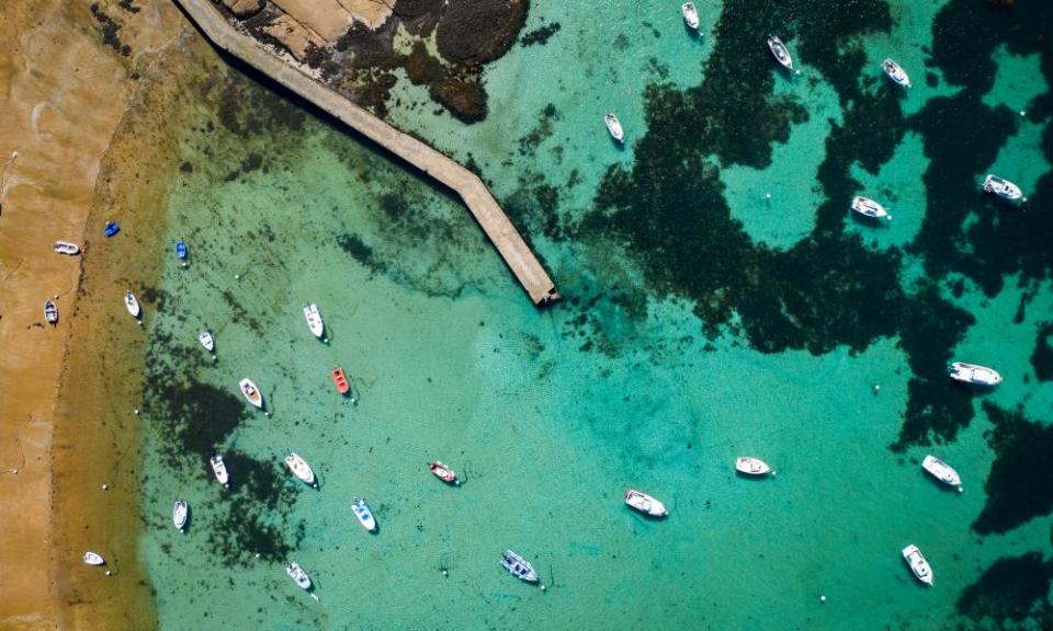 Blue waters in Bretagne, Tregastel and the amazing “cote de Granite rose”This photo was taken in Tregastel near Perros-Guirrec .This is the cote de Granit Rose with beautiful blue waters rocks and boats. This is an aerial photo.