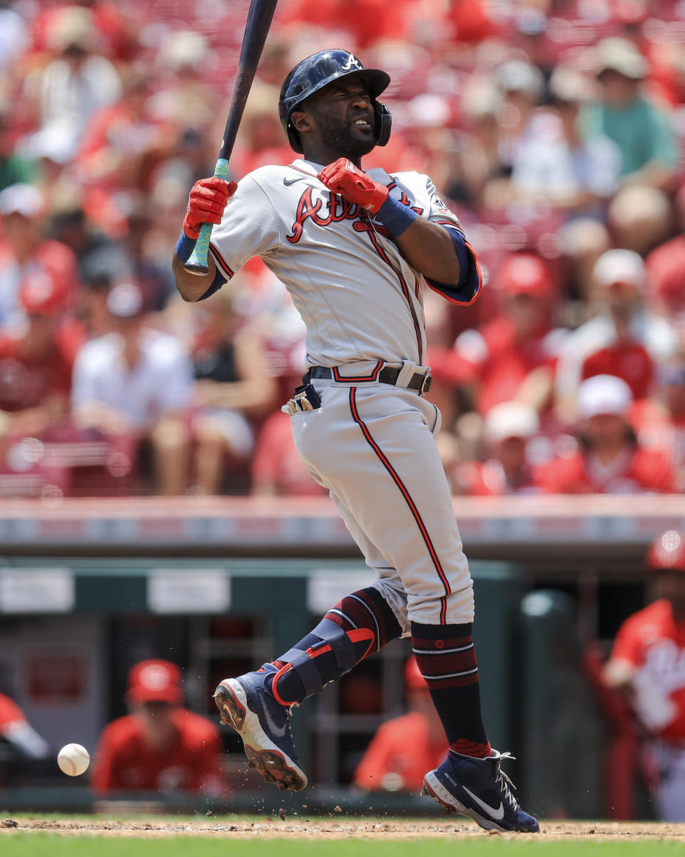 Atlanta Braves' Guillermo Heredia reacts after being hit by a pitch from Cincinnati Reds' Tyler Mahle during the third inning of a baseball game in Cincinnati, Sunday, June 27, 2021. (AP Photo/Aaron Doster)