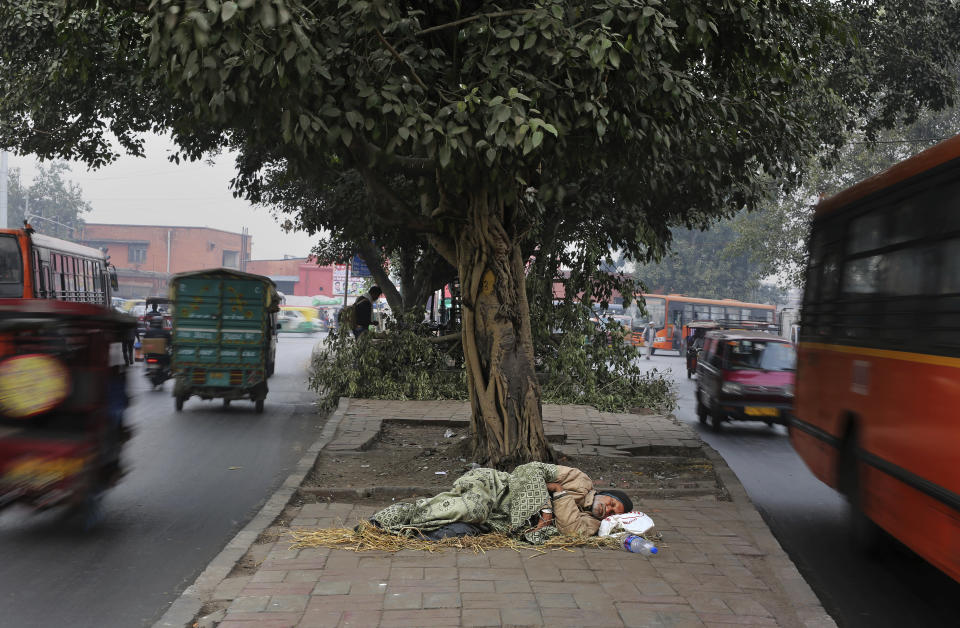 <p>A homeless man sleeps on a road divider in New Delhi, India, Wednesday, Jan. 16, 2019. Some 800 million people in the country live in poverty, many of them migrating to big cities in search of a livelihood and often ending up on the streets. (AP Photo/Altaf Qadri) </p>