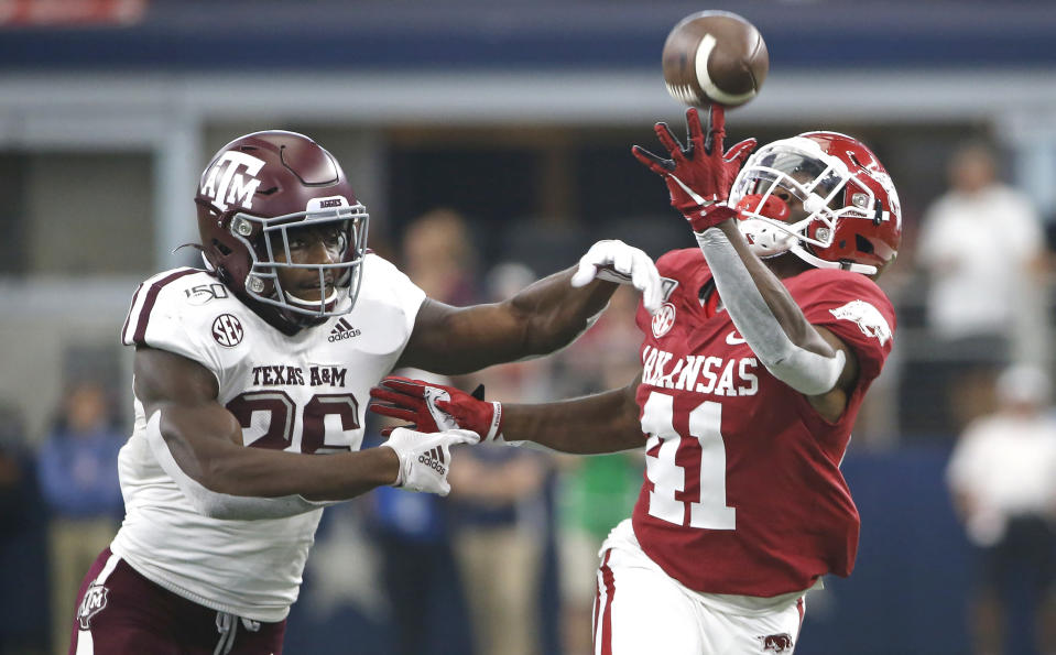 Texas A&M defensive back Demani Richardson (26) defends as Arkansas running back T.J. Hammonds (41) fails to make a catch during the second half of an NCAA college football game Saturday, Sept. 28, 2019, in Arlington, Texas. Texas A&M won 31-27. (AP Photo/Ron Jenkins)