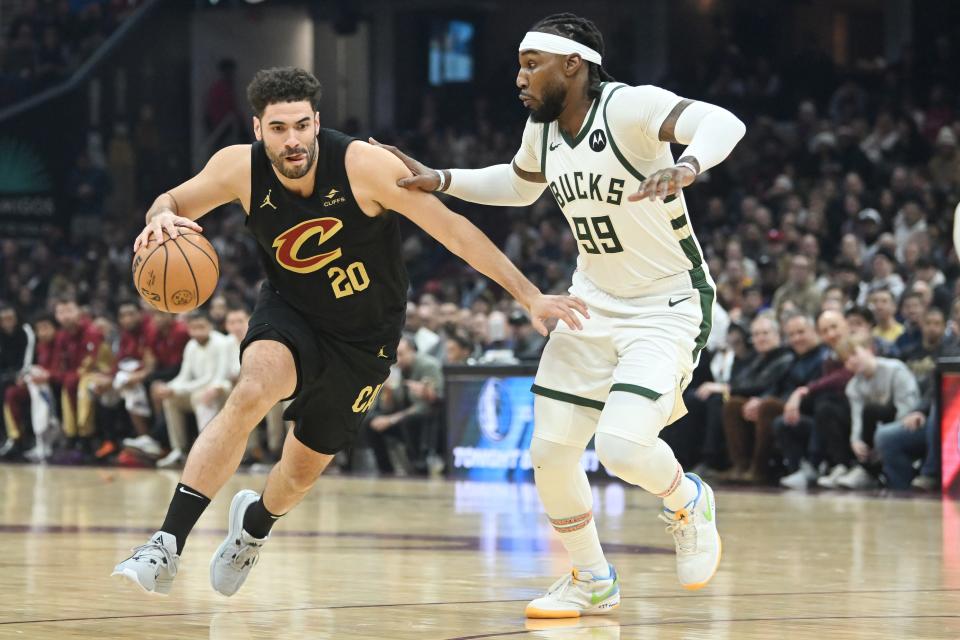 Cleveland Cavaliers forward Georges Niang (20) drives to the basket against Milwaukee Bucks forward Jae Crowder (99) on Wednesday in Cleveland.