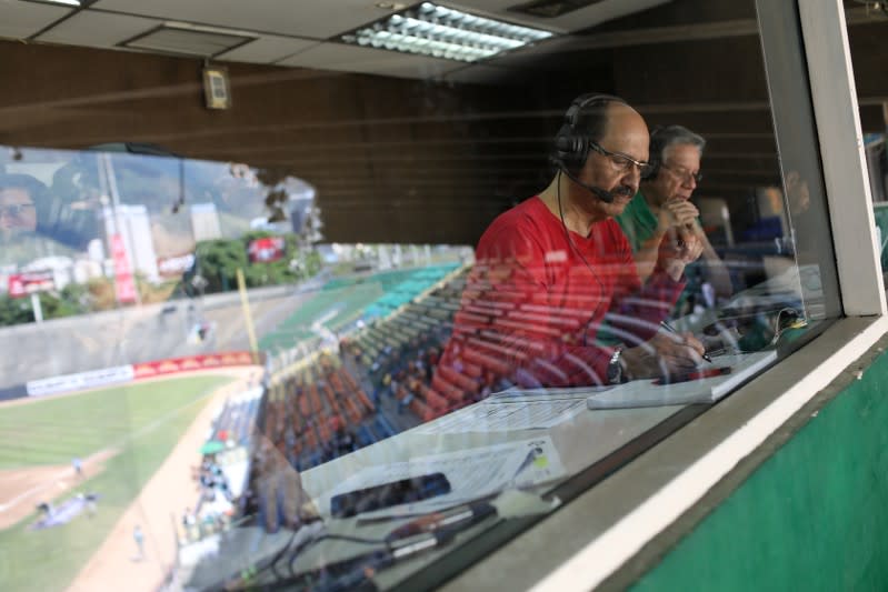 Journalist take notes during a Venezuela baseball league game at University Stadium in Caracas