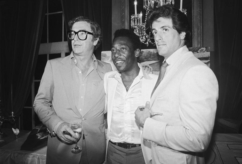 (L-R) Michael Caine, soccer great Pele, and Sylvester Stallone at a party celebrating the 7/16 opening of the film 
