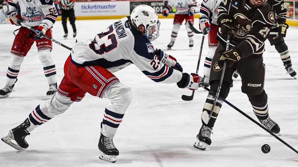 Hendrix Lapierre (29) shoots the puck as Victor Mancini (23) attempts to block it. The Hershey Bears played the Hartford Wolf Pack in the first game of their best-of-five Atlantic Division finals series Thursday, May 16, 2024 at Giant Center