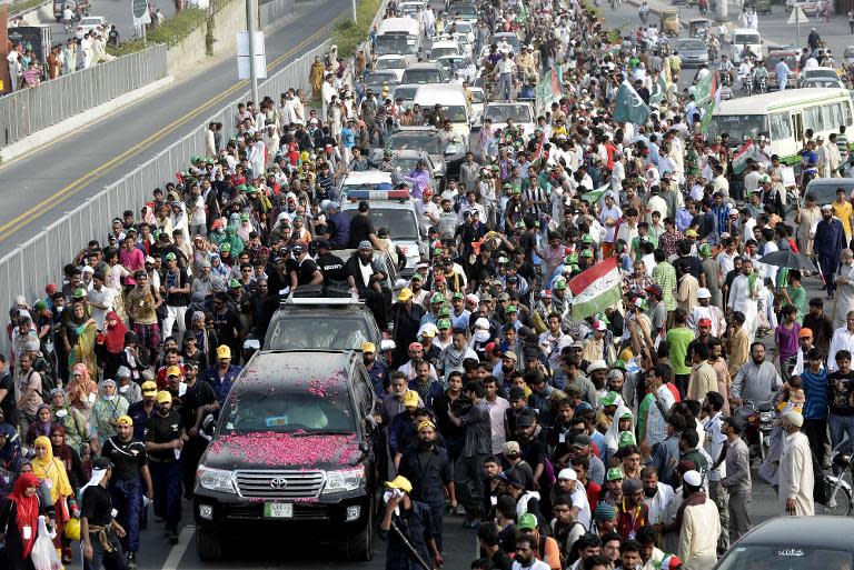 Supporters of preacher Tahir-ul-Qadri during a protest in Pakistan's eastern city of Lahore on August 14, 2014, as they take part in a protest march to Islamabad