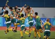 ATHENS - AUGUST 27: Australia celebrate their gold medal win after a Jamie Dwyer goal in extra time sealed the win in the men's field hockey event on August 27, 2004 during the Athens 2004 Summer Olympic Games at the Helliniko Olympic Complex Hockey Centre in Athens, Greece. (Photo by Clive Brunskill/Getty Images)