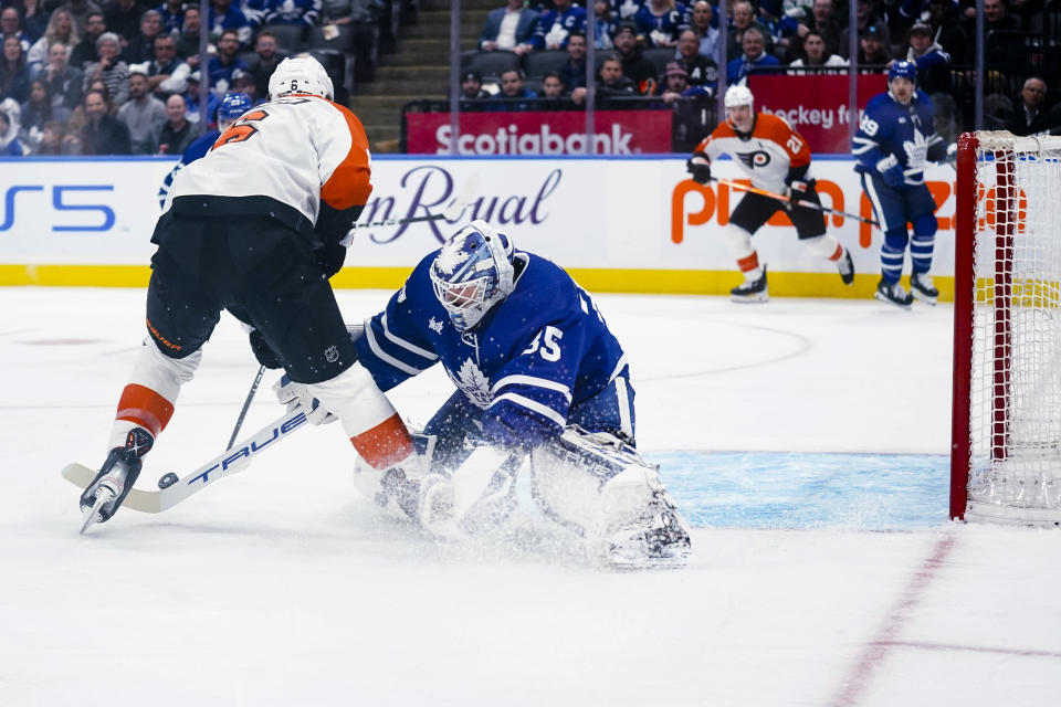 Philadelphia Flyers defenseman Travis Sanheim (6) is stopped by Toronto Maple Leafs goaltender Ilya Samsonov (35) during the first period of an NHL hockey game Thursday, Feb. 15, 2024, in Toronto. (Arlyn McAdorey/The Canadian Press via AP)