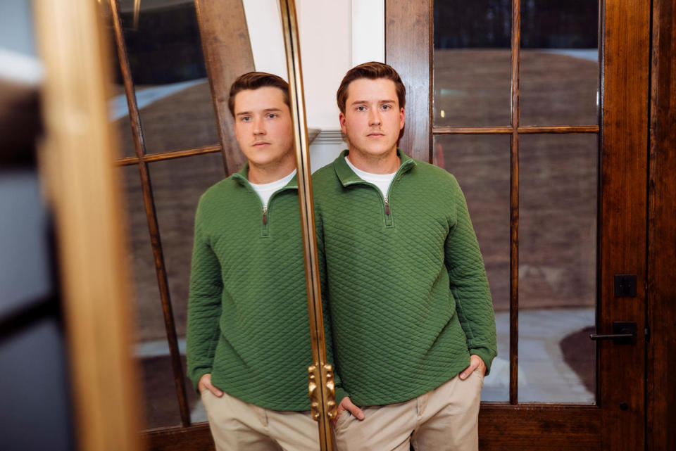 Jace Curry poses for a portrait next to a mirror reflecting him (Kendrick Brinson for NBC News)