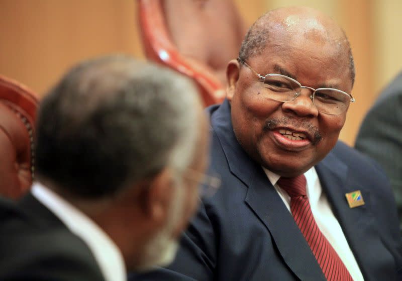 FILE PHOTO: Tanzania's former President Mkapa speaks with Sudan's Foreign Minister Karti during a meeting in Khartoum