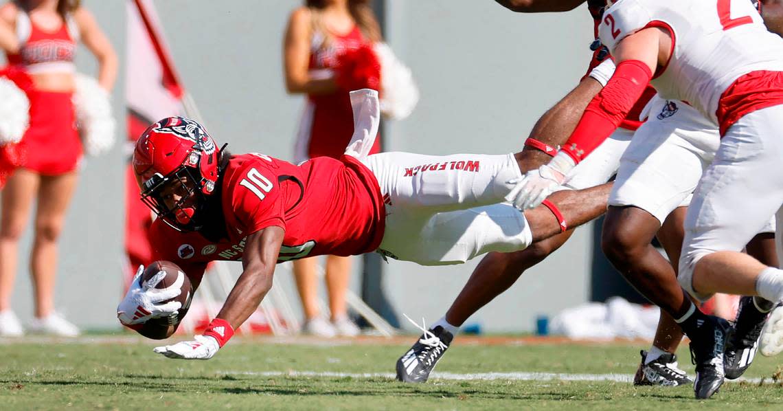 N.C. State wide receiver Kevin ‘KC’ Concepcion (10) dives for extra yards after making a reception during the second half of the Wolfpack’s 45-7 victory over VMI at Carter-Finley Stadium in Raleigh, N.C., Saturday, Sept. 16, 2023.