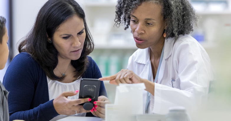 patient and doctor looking at mobile phone