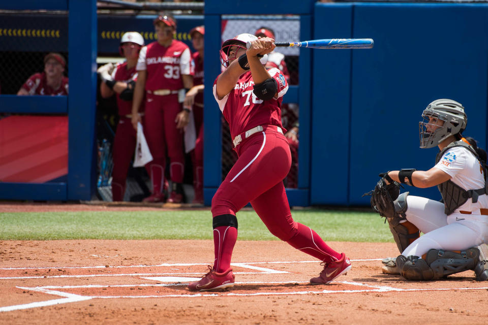 Jun 4, 2022; Oklahoma City, Oklahoma, USA;  Oklahoma Sooners utility Jocelyn Alo (78) hits a home run during the first inning of the NCAA Women's College World Series game against the Texas Longhorns at USA Softball Hall of Fame Stadium. Mandatory Credit: Brett Rojo-USA TODAY Sports