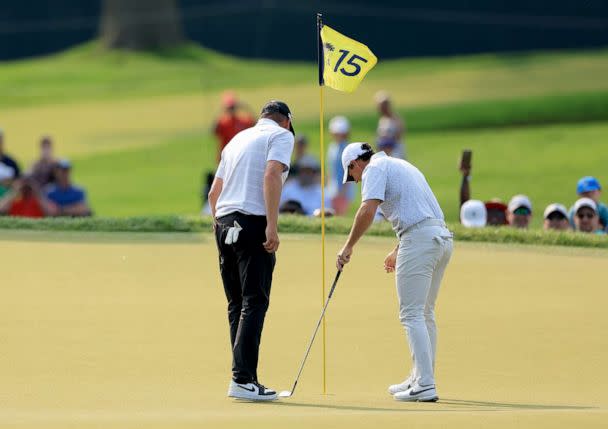 PHOTO: Michael Block, examines the hole for damage after he had holed-in-one on the 15th hole with his playing partner Rory McIlroy during the final round of the 2023 PGA Championship at Oak Hill Country Club on May 21, 2023 in Rochester, N.Y. (David Cannon/Getty Images)