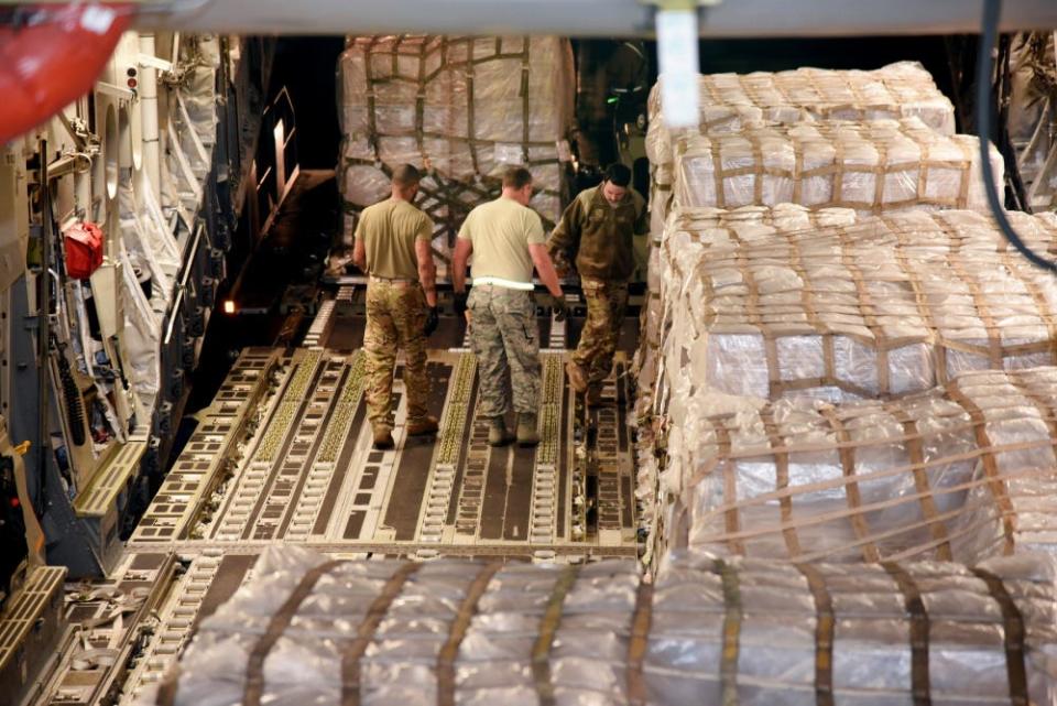 Air crew from Travis Air Force Base and the 164th Airlift Wing unload COVID-19 testing swabs at the Memphis Air National Guard Base in Memphis, Tennessee, March 19, 2020.