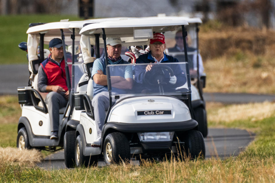 President Donald Trump drives a golf cart as he plays golf at Trump National Golf Club in Sterling, Va., Sunday, Dec. 13, 2020. (AP Photo/Manuel Balce Ceneta)