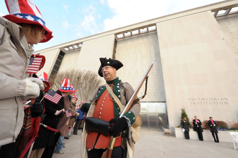 A man portraying a Revolutionary War soldier describes his garb to guests during a ceremony for the reopening of the National Museum of American History in Washington on November 21, 2008. On September 19, 1777, American soldiers won the first Battle of Saratoga in the Revolutionary War. File Photo by Roger L. Wollenberg/UPI