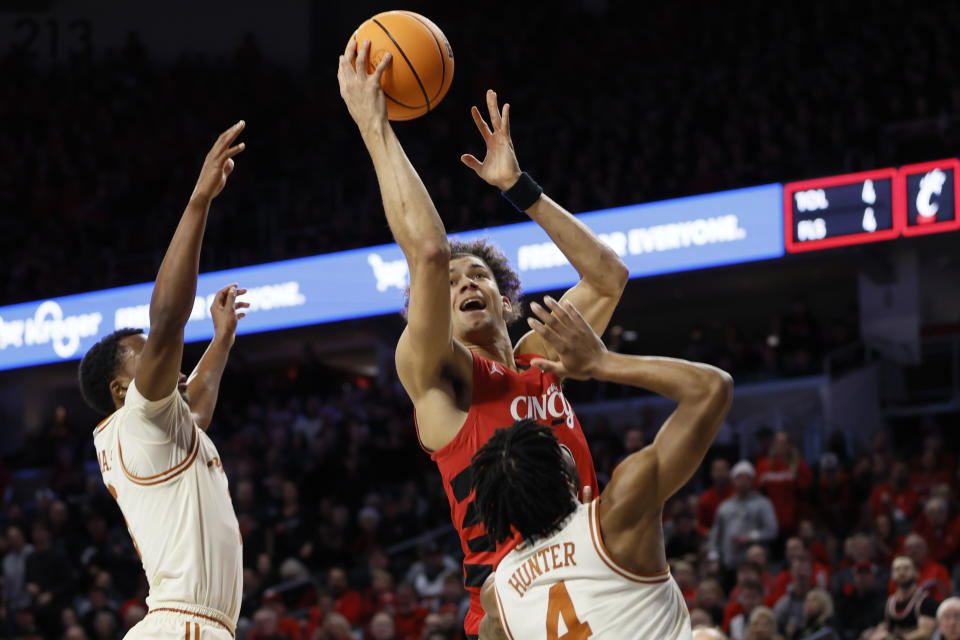 Cincinnati's Dan Skillings shoots over Texas' Tyrese Hunter (4) during the first half of an NCAA college basketball game Tuesday, Jan. 9, 2024, in Cincinnati. (AP Photo/Jay LaPrete)