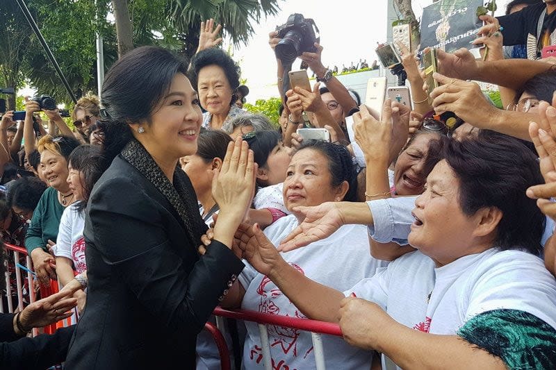 Ousted former Thai prime minister Yingluck Shinawatra greets supporters as she leaves the Supreme Court in Bangkok on August 1, 2017 - Aukkarapon Niyomyat/Reuters