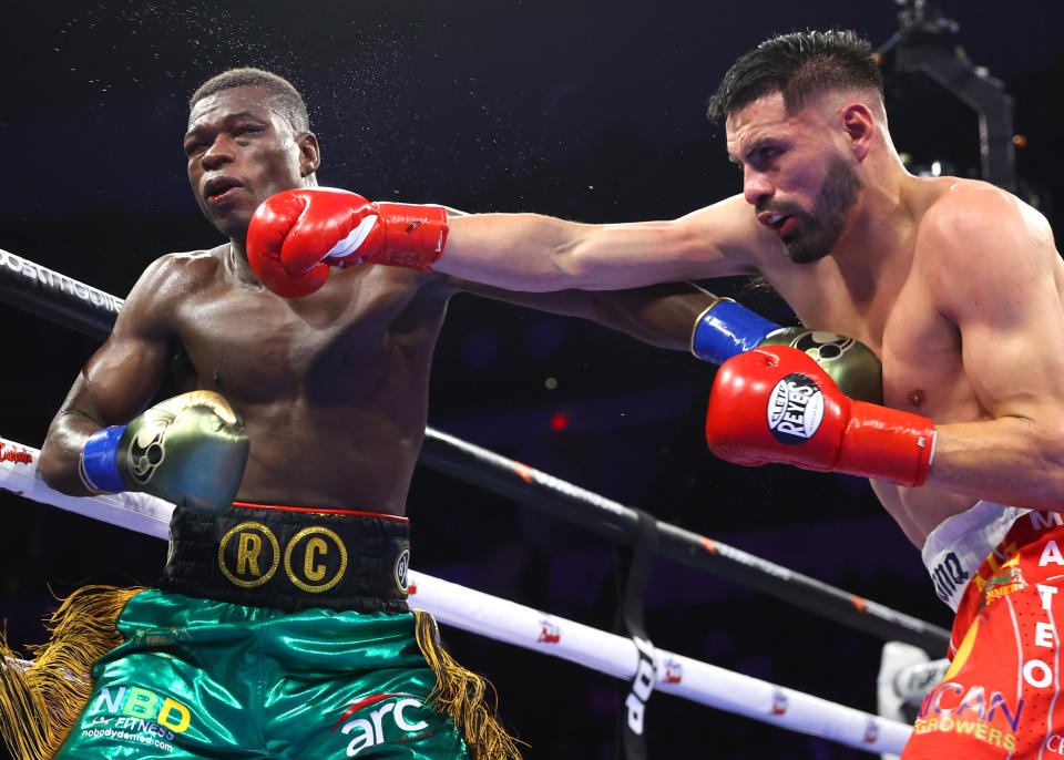 FRESNO, CALIFORNIA - MARCH 25: Richard Commey (L) and Jose Ramirez (R) exchange punches during their junior welterweight fight at Save Mart Center on March 25, 2023 in Fresno, California. (Photo by Mikey Williams/Top Rank Inc via Getty Images)