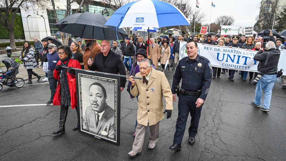 Dr. Sudarshan Kapoor, center, helps lead the 39th annual Martin Luther King Jr Day March from Fresno City Hall to the Fresno Veterans Memorial Auditorium on Monday, Jan. 16, 2023.