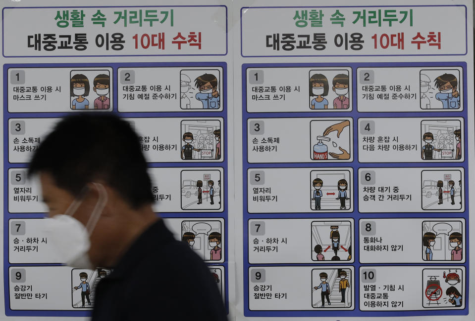 A man wearing a face mask walks past a banner showing precautions against the coronavirus at subway station in Seoul, South Korea, Thursday, Sept. 10, 2020. (AP Photo/Lee Jin-man)