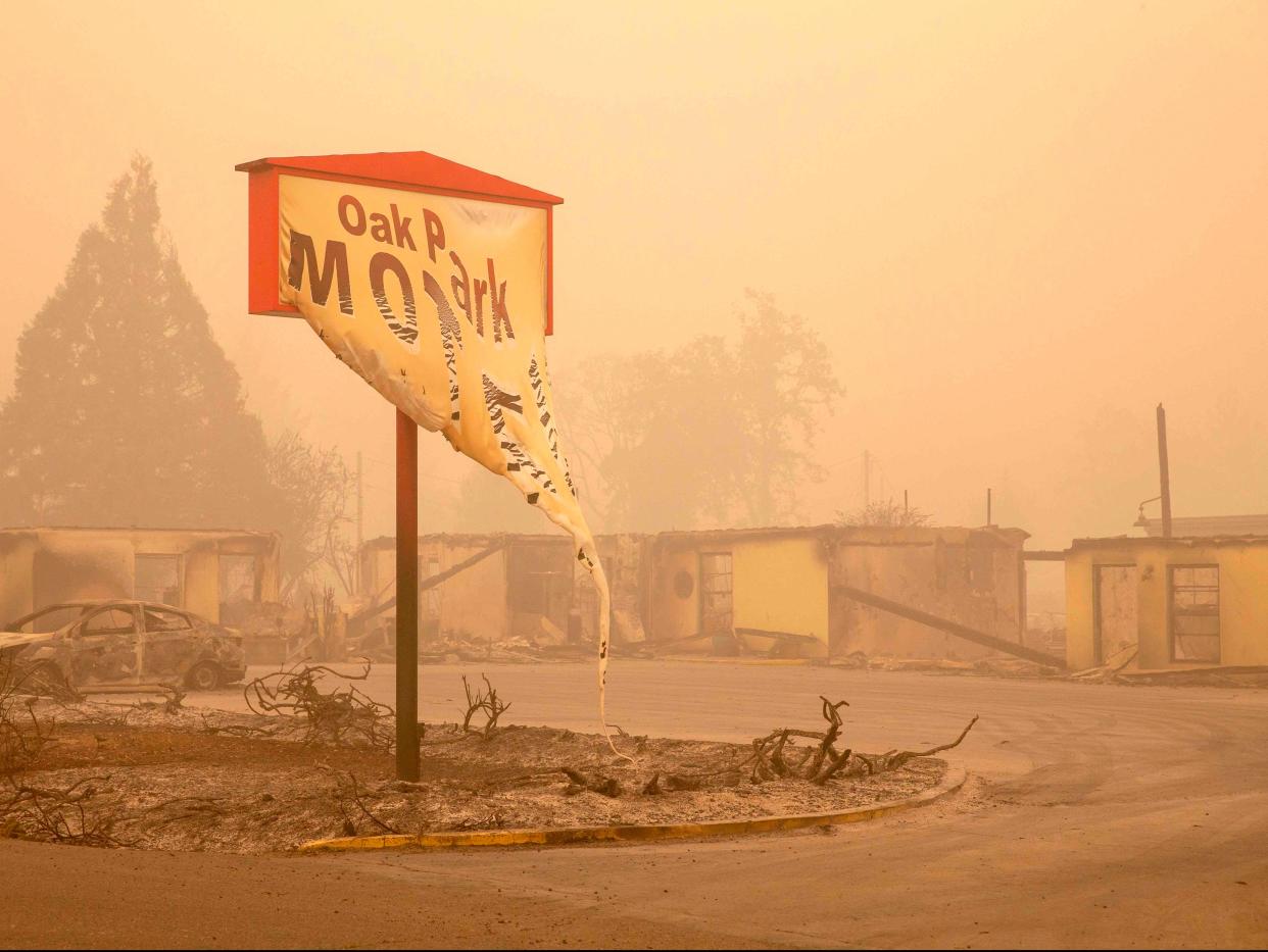 The melted sign of the Oak Park Motel destroyed by the flames of the Beachie Creek Fire is seen in Gates, east of Salem, Oregon (POOL/AFP via Getty Images)