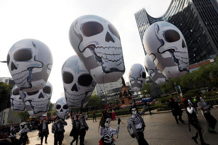 Balloons depicting skulls are pictured in a procession to commemorate Day of the Dead in Mexico City, Mexico, October 28, 2017. REUTERS/Edgard Garrido