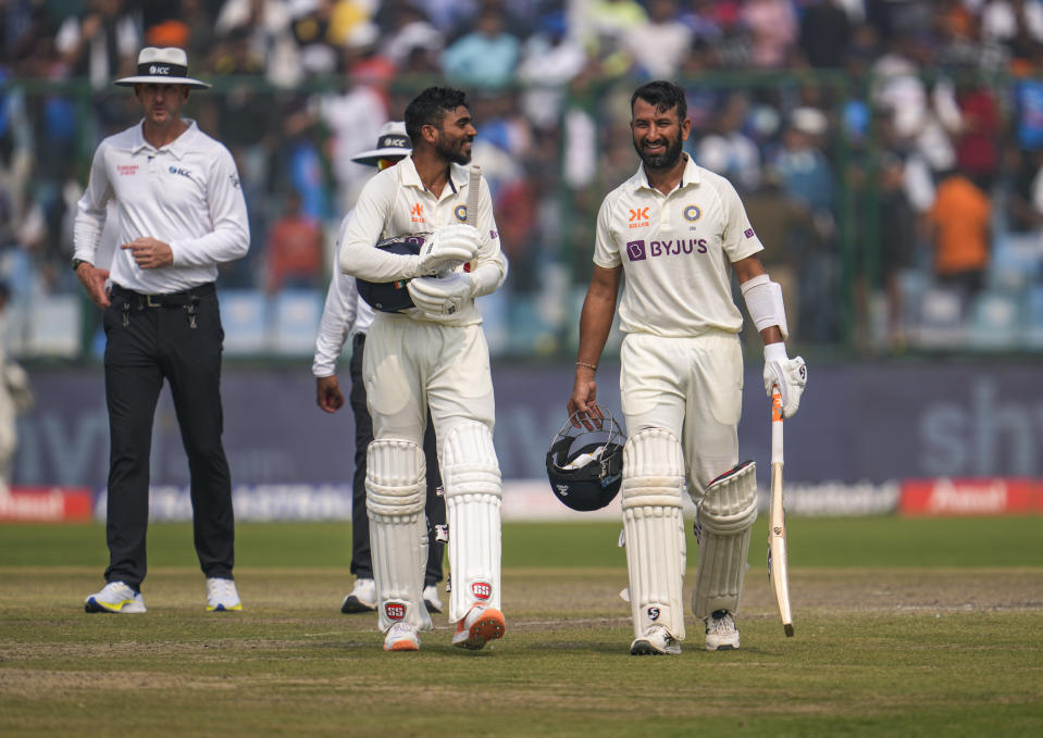 India's Cheteshwar Pujara, right and Srikar Bharat celebrate winning the second cricket test match between India and Australia in New Delhi, India, Sunday, Feb. 19, 2023. (AP Photo/Altaf Qadri)