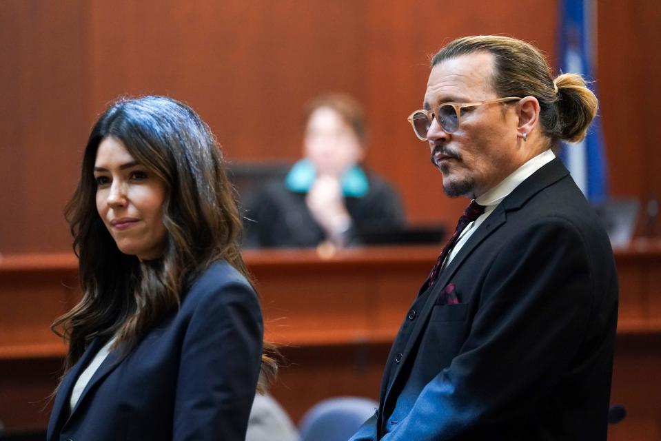 Johnny Depp stands next to his lawyer Camille Vasquez in the courtroom for his defamation lawsuit against Amber Heard. (Kevin Lamarque/Pool Photo via AP) ORG XMIT: WX308