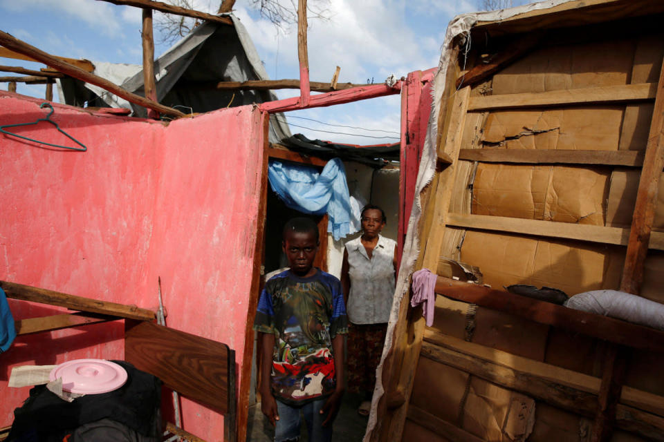 <p>Gina Petroz (right) and Wadley Jon Michel, pose for a portrait in their destroyed house after Hurricane Matthew passes Jeremie, Haiti, October 7, 2016. (REUTERS/Carlos Garcia Rawlins)</p>