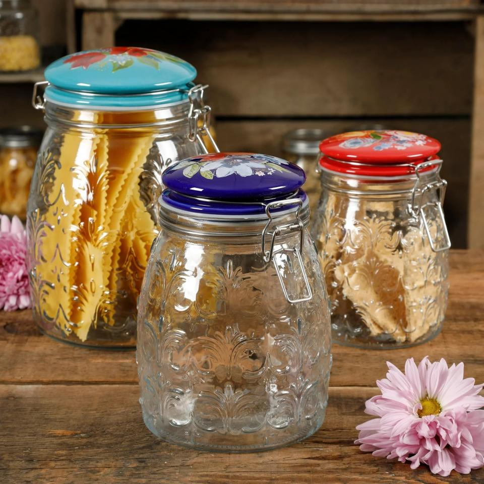 three glass jars with embossed floral lids