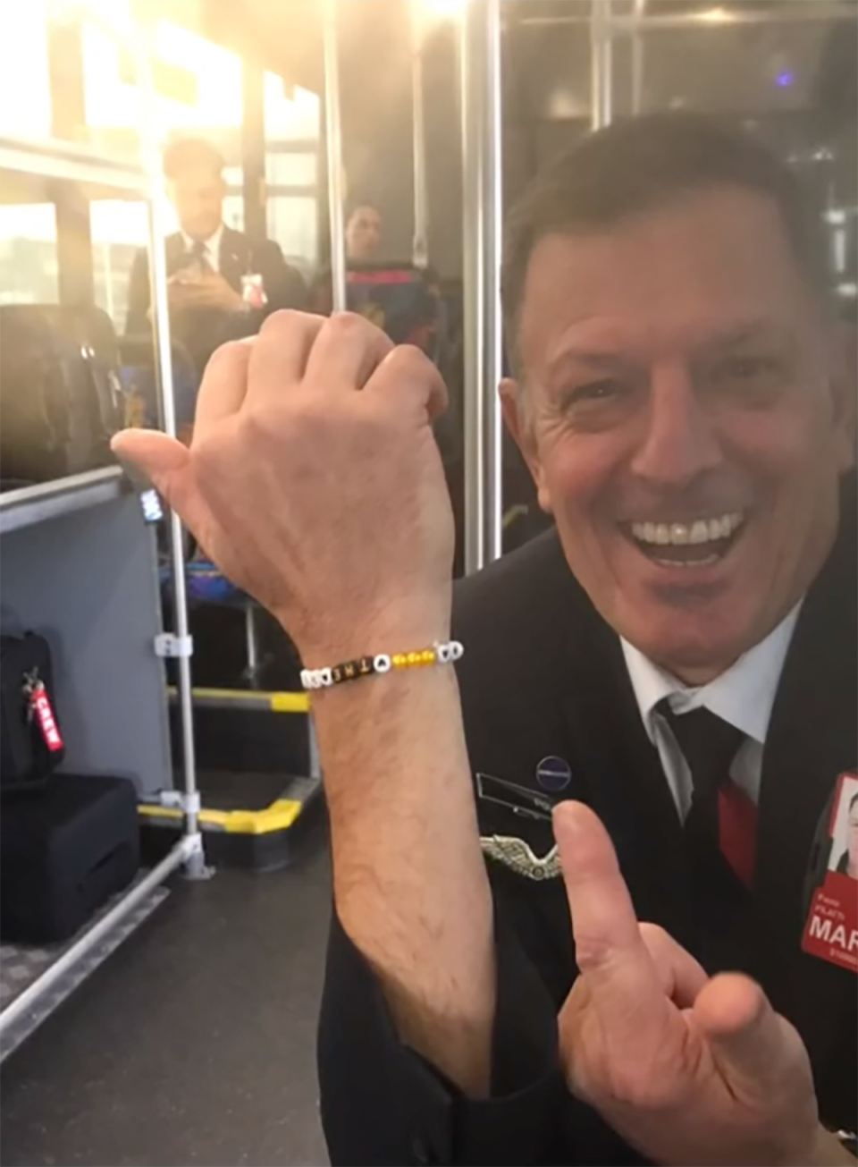 Qantas cabin crew member Paul Pillati posing with a friendship bracelet.