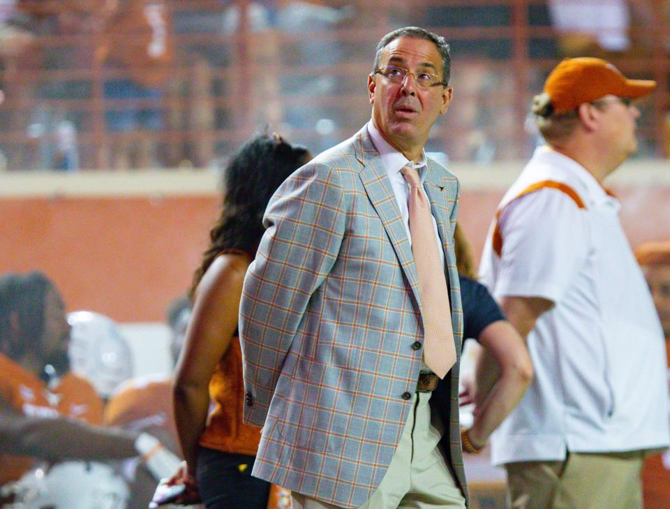 Texas athletic director Chris Del Conte checks the scoreboard at Royal-Memorial Stadium during the 2021 football game against Rice. He's on his way to Kansas City to watch some basketball.