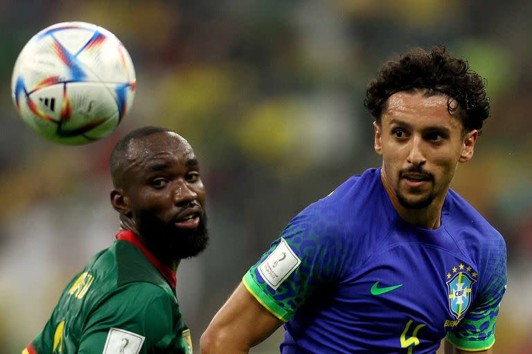 Brazil's defender #04 Marquinhos (R) eyes the ball as he fights for it with Cameroon's forward #06 Nicolas Moumi Ngamaleu (L) during the Qatar 2022 World Cup Group G football match between Cameroon and Brazil at the Lusail Stadium in Lusail, north of Doha on December 2, 2022. (Photo by Adrian DENNIS / AFP)