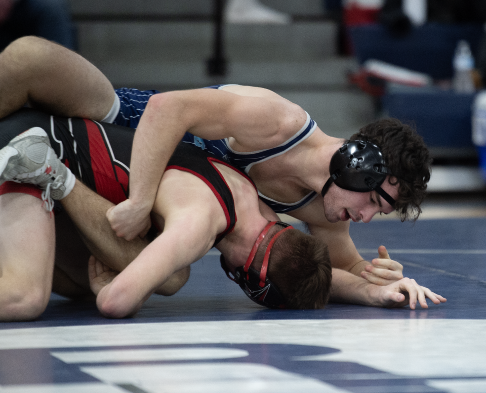 Rootstown's Nick Malek, shown wrestling against Perry, won a sectional championship Saturday.