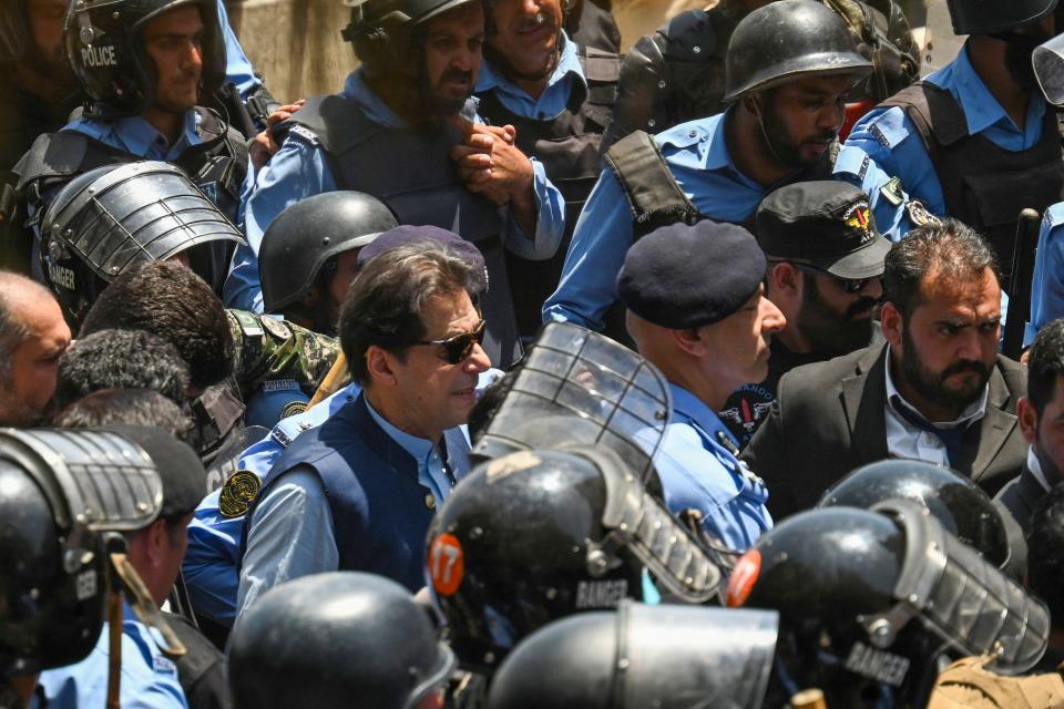 Police escort Pakistan's former Prime Minister Imran Khan (C) as he arrives at the Islamabad High Court, May 12, 2023.  / Credit: AAMIR QURESHI/AFP/Getty