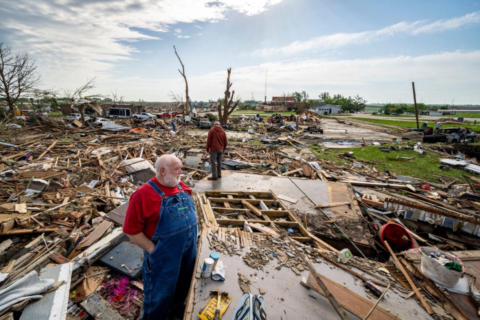 Gary Randel looks for his daughter's belongings in the remains of her home in Greenfield, Wednesday, May 22, 2024. Multiple residents were killed when a tornado struck the town Tuesday afternoon.