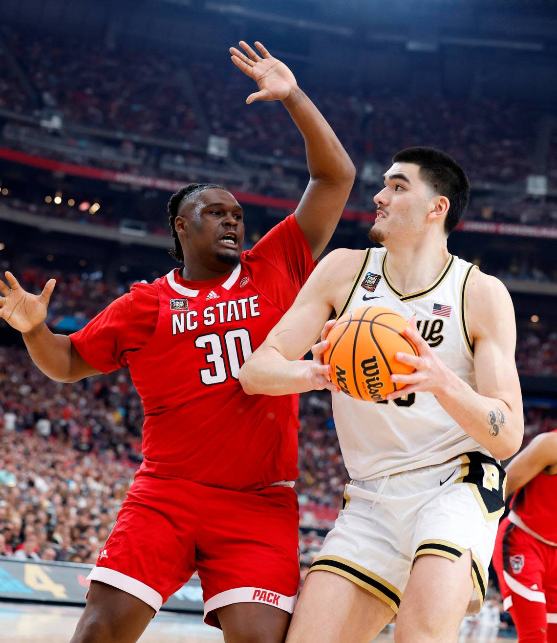 NC State’s DJ Burns defends against Purdue center Zack Edey early in the first half of their NCAA Final Four game, Saturday evening, April 6, 2024. Ethan Hyman/ehyman@newsobserver.com