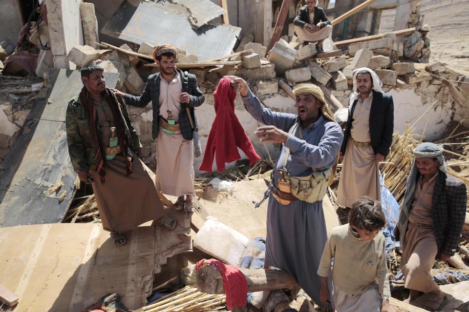 A man center, holds house destroyed by a Saudi-led airstrikes in outskirts of Sanaa, Yemen, Thursday, Feb. 16, 2017. At least one Saudi-led airstrike near Yemen's rebel-held capital killed at least five people on Wednesday, the country's Houthi rebels and medical officials said. (AP Photo/Hani Mohammed)